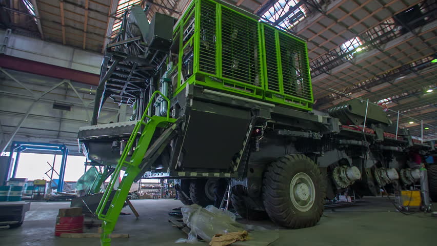 Big mining machine in the middle of a hall of a work shop getting build to go on a mining sites.