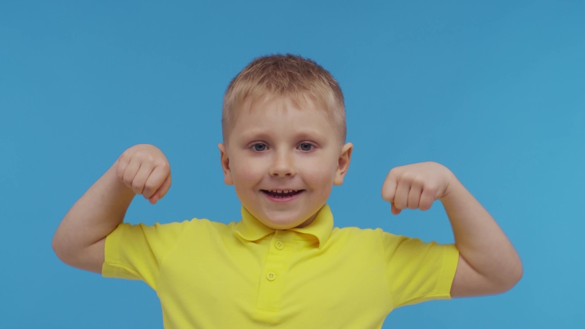 Portrait of happy smiling boy in t-shirt. Attractive and expressive kid in studio.