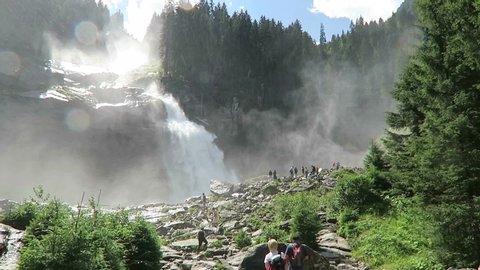 Krimml , Salzburger Land / Austria - 07 28 2016: People walking on rocks to get a good view on Krimml Waterfalls in Austria.