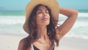 Beautiful girl with straw hat enjoying sunbath at beach. Close up face of young tanned woman with closed eyes enjoying breeze at seaside. Carefree latin woman smiling with ocean in background. - Powered by Shutterstock - Get 15% off with code: PIKWIZARD15