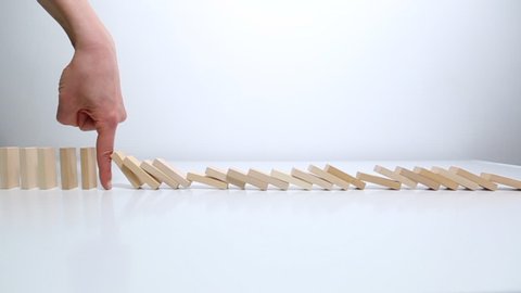 Stops falling dominoes. Strategy for successfully solving a problem in business. Financial risks. Crisis concept.