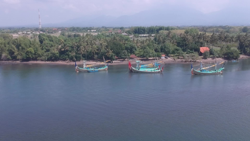 span over water visible shore Prancak Perancak west bali many traditional Balinese boats