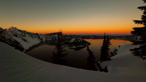Lockdown time lapse shot of Crater Lake amidst snowcapped mountains against sky