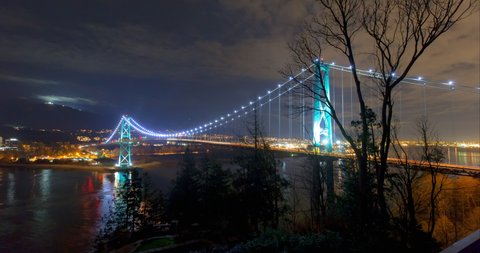 Lockdown time lapse shot of famous bridge over sea against sky seen from Prospect Point at night - Vancouver, Canada