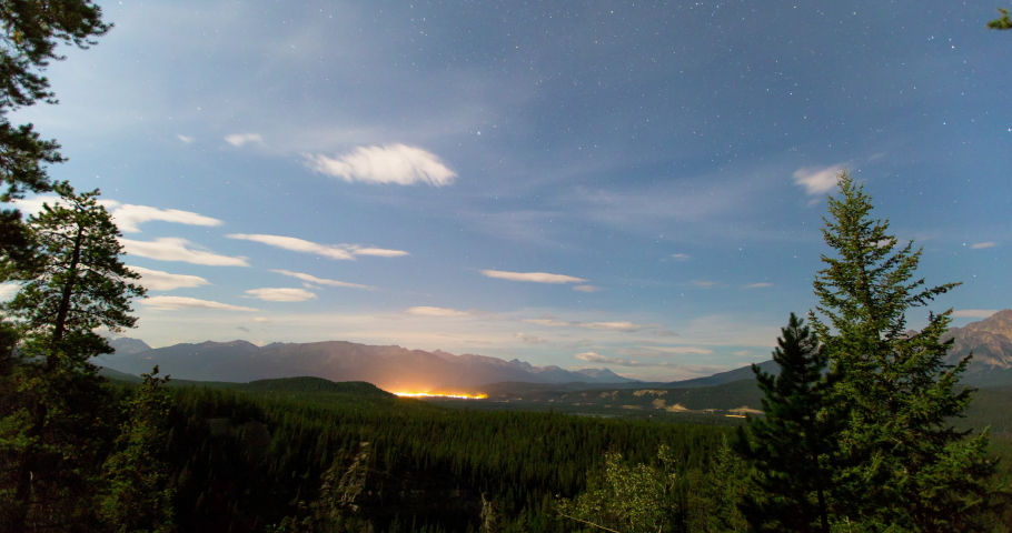 Lockdown time lapse shot of green trees in forest against sky at night - Jasper National Park, Canada