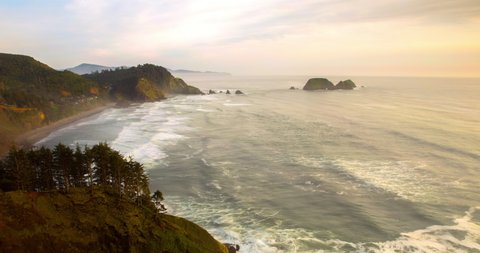 Tilt down time lapse shot of waves splashing on rocky coastline against sky during sunset - Oregon, Oregon