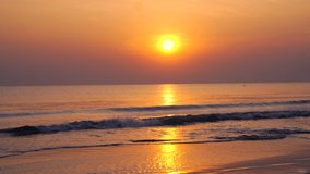 Beautiful sunrise on the sea beach. Calm clear sea and sun over the waves. The Beach Of Hua Hin Thailand