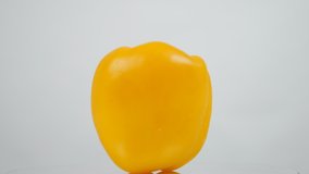 Bell pepper turning slow motion on white background