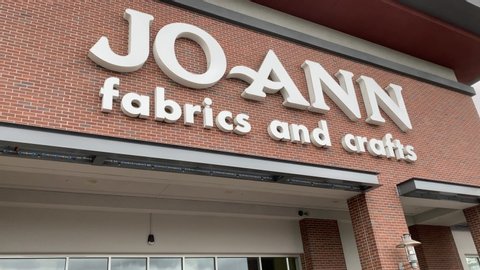 Fremont, CA / USA - May 12 2020: Joann Fabrics and Crafts COVID-19 store front open for curb side. Wide video shot of curbside service.