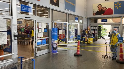 Fremont, CA / USA - May 14 2020: Walmart COVID-19. Wide shot entrance customer disobey rules.