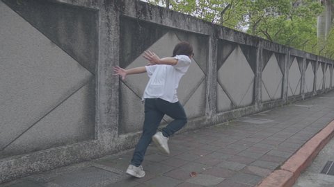 Asian guy is doing Naruto Run on street