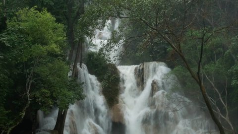 Tropical rainforest waterfalls after rain in monsoon season nature background, high humidity forest around Tat Kuang Si waterfalls or Kuang Si falls in Luang Prabang, Laos.