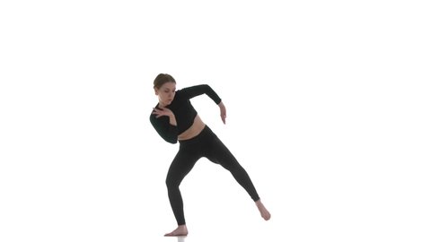 young beautiful woman dancer in black short top and black leggings emotionally dancing contemporary, modern ballet dance, isolated, slow motion