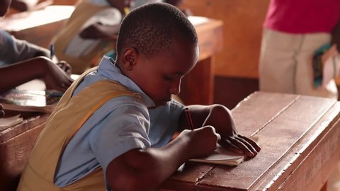 Embu/Kenya 10/‎23/‎2018 : Young child in rural Africa looking at the teacher and taking notes. Young girld child in rura Africa paying attention in class