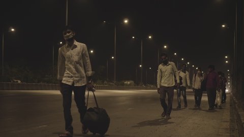 Migrant workers carrying luggage walking home due to lack of Public transport during a national lockdown amid Coronavirus/ COVID19/ Corona Pandemic/ Epidemic, Mumbai, India (May 2020)