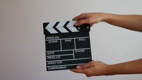 Female holding wooden clapperboard. Cinematography production concept. Copy space advertising mock up.