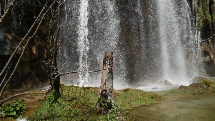Large waterfall in the Plitvice Lakes National Park in Croatia. The Korana River, caused travertine barriers to form natural dams, which created a number of picturesque lakes, waterfalls and caves.