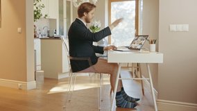 Funny Clip: Businessman Wearing Jacket and No Pants Uses Laptop and Conference Video Call Software App for a Board of Directors Online Meeting. Remote Work, Work at Home, Home Office Concept.Side View