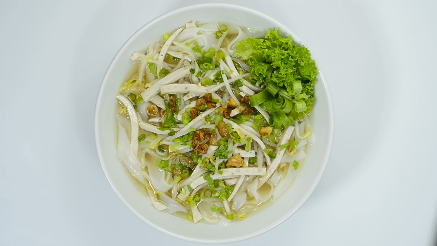 
Rice Noodles with Vietnamese Pork Saucesage Slice sprinkle with crispy Garlic and Spring Onions Asian Popular dish in Laos and Vietnamese Food style decorate with vegetables topview