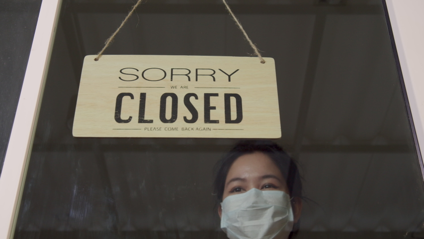 Asian woman wear mask turning Welcome we are open sign on fronton glass door store. Reopening activity after COVID-19, ended the lockdown and quarantine. Restarting again and keep forward concept Royalty-Free Stock Footage #1052506894