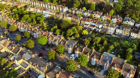 London victorian Suburb, aerial shot, golden hour, beautiful green area 4K
