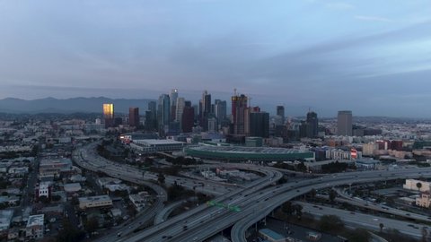 down town Los Angeles by the 110 and 10 freeway interchange showing traffic and cars driving through the city