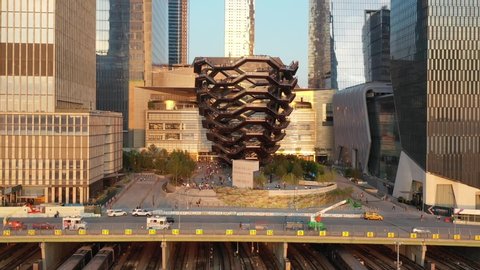 NEW YORK - CIRCA 2020 - Aerial of tourists climbing the Vessel, an artistic outdoor spiral staircase, in the Hudson Yards of New York City, New York.