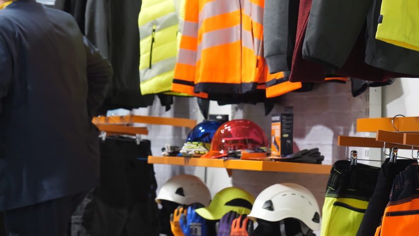Safety workwear and personal protective equipment display in the industrial clothing shop. Royalty-Free Stock Footage #1052520223
