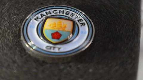 Miami, FL, USA - May 10, 2020: Slow motion speed spinning rotation movement of Manchester City British football/soccer sports team champions in Premier League blue logo icon pin 