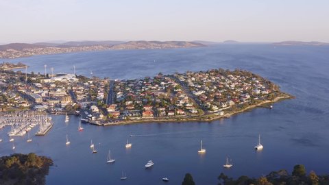 Aerial high angle footage moving over Rosny Hill Lookout, Bellerive, Kangaroo Bluff Reserve and Bellerive Beach on the banks of the Derwent River east of Hobart, Tasmania, Australia