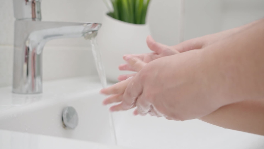 Mom washes baby hands with soap protecting against coronavirus to prevent COVID Royalty-Free Stock Footage #1052524693