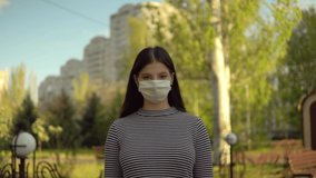 Girl pake off medical protective mask looking at camera, coronavirus