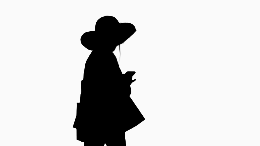 Silhouette Woman in summer outfit using mobile walking.