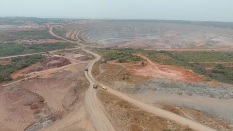 Africa, Angola. Big trucks work in a quarry. Extraction of diamonds, coal, ore and minerals. 
