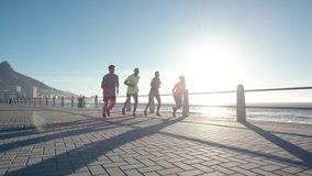 Group of young people running on ocean front. Runners in sportswear training together outdoors on a sunny day.
 - Powered by Shutterstock - Get 15% off with code: PIKWIZARD15