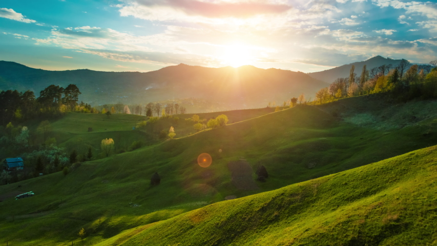 Beautiful sunset light over green grass covered mountain and hills landscape timelapse	 | Shutterstock HD Video #1052547812