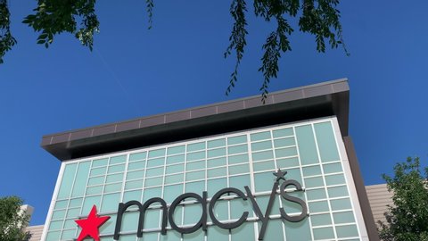 Gilbert, Arizona / USA - May 15 2020: Pan of Macy's Department Store front doors closed with blue sky