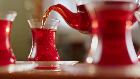 Slow motion.It fills Turkish tea into a glass special to the Turks.