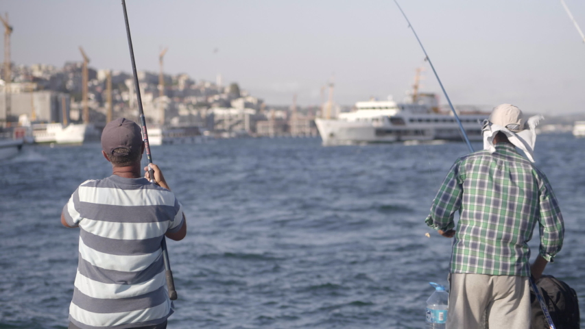 Fishermen fishing near Galata Bridge in Istanbul port Bosphorus