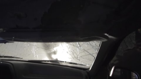 Rollover in car crash of a truck by night, windshield breaks.