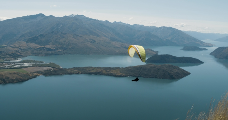 Paraglider over the mountains and lake in New Zealand Royalty-Free Stock Footage #1052573534