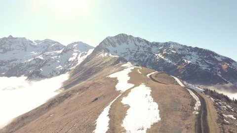DRONE FOOTAGE UP - Snow and mountain peaks in the french Pyrenees near the Luchon Superbagnères Ski Resort in Saint-Aventin, France. The Luchonnais Mountains aerial view.