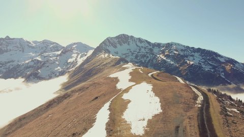 DRONE FOOTAGE DOWN - Snow and mountain peaks in the french Pyrenees near the Luchon Superbagnères Ski Resort in Saint-Aventin, France. The Luchonnais Mountains aerial view.