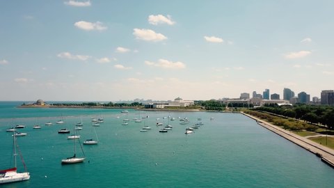 Drone Aerial video of Chicago, sunny day a lot Boats Parked in Bay at Bright Sunny Day.