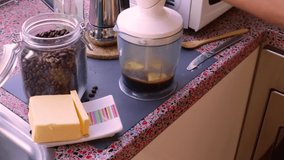 Person making bulletproof coffee with butter and MCT oil