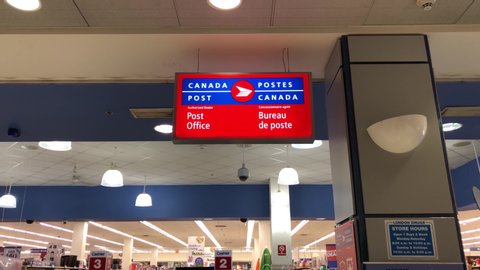 Coquitlam, BC, Canada - May 11, 2020 :  Motion of post office sign on roof inside Coquitlam center mall with 4k resolution