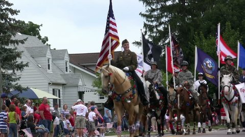 FAIRBORN, OHIO - JULY 4 : Horses with flags in Celebratory parade for the United States of America on July 4, 2009 in Fairborn, Ohio. Video Stok Editorial