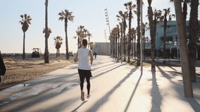 Conceptual shot of young sporty man running in the morning along seaside