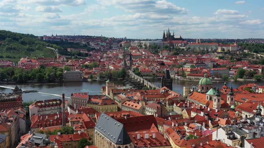 Panoramic view from above on the Prague center, aerial of the Prague city, view from above on the cityscape of Prague, flight over the city, top view, Vltava River, Charles Bridge, Prague, Czechia. | Shutterstock HD Video #1052622827