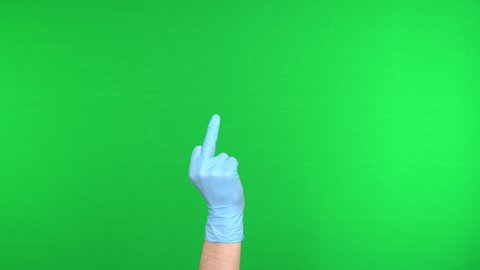 Fuck you hand gesture in medical glove. Isolated middle finger, offensive gesture. Coronavirus pandemic (Covid-19). Chroma key, Chromakey background, Green screen